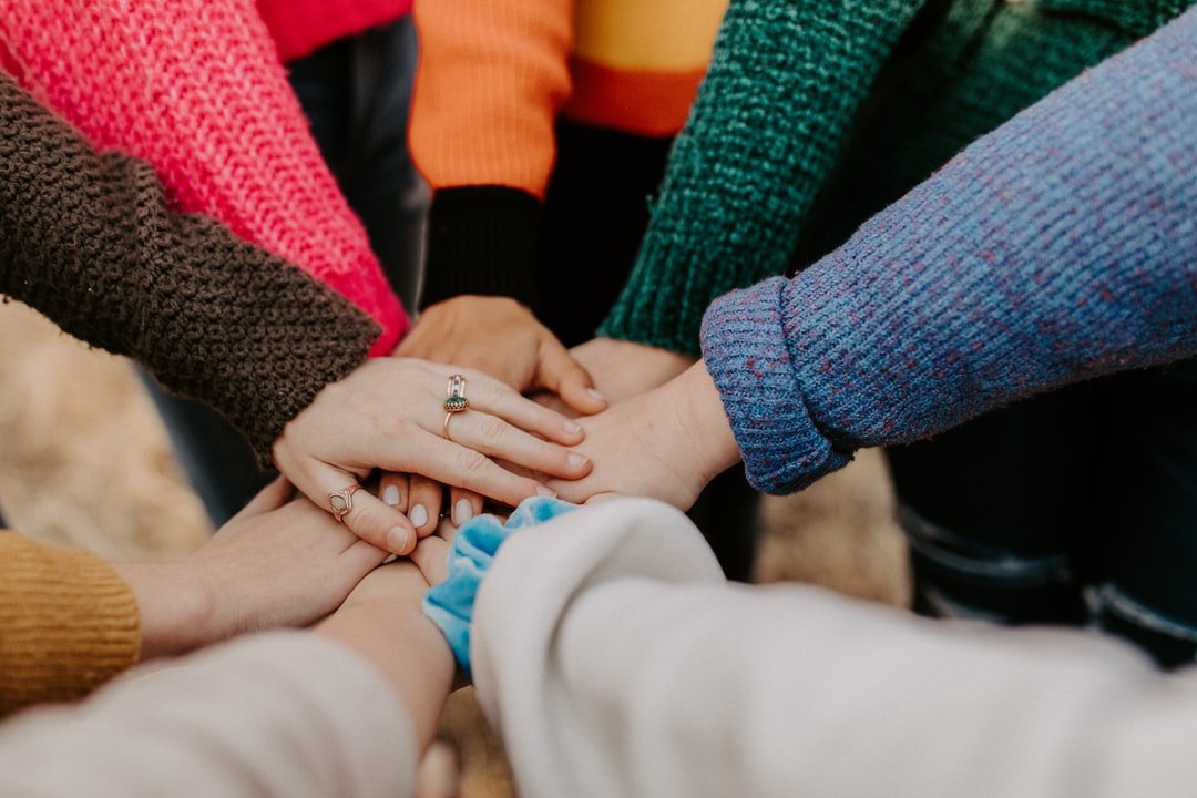 Group of people with hands in the center